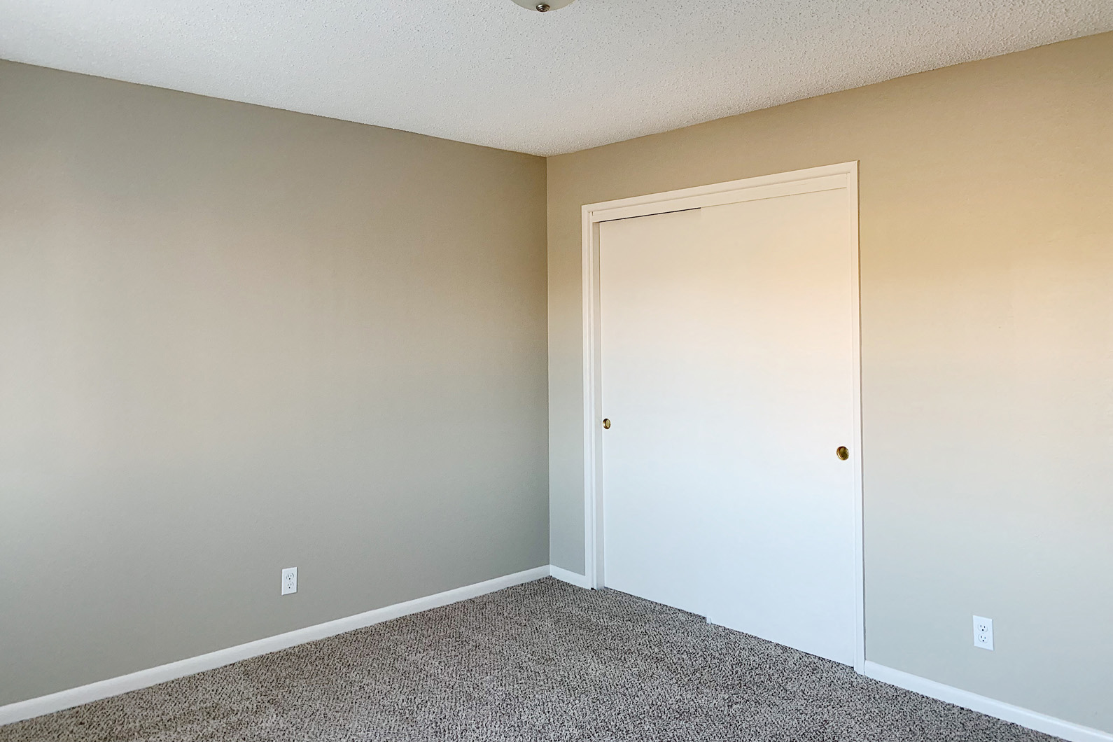 an empty bedroom with a white door