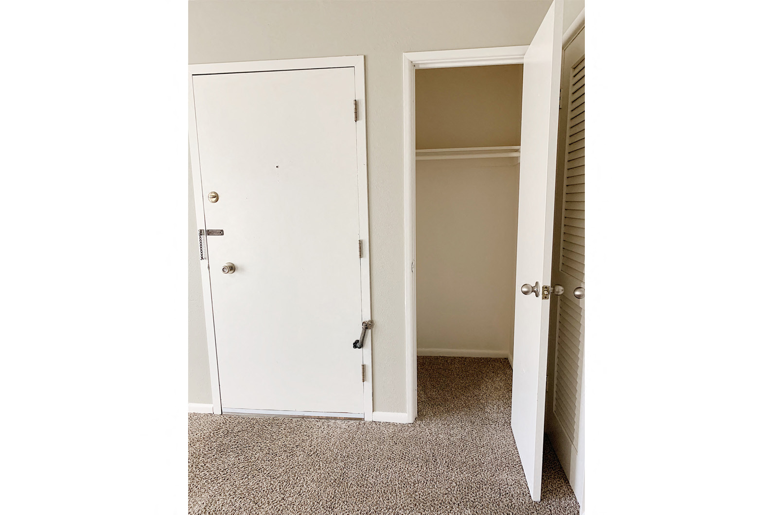 an open closet with a door open to a room
