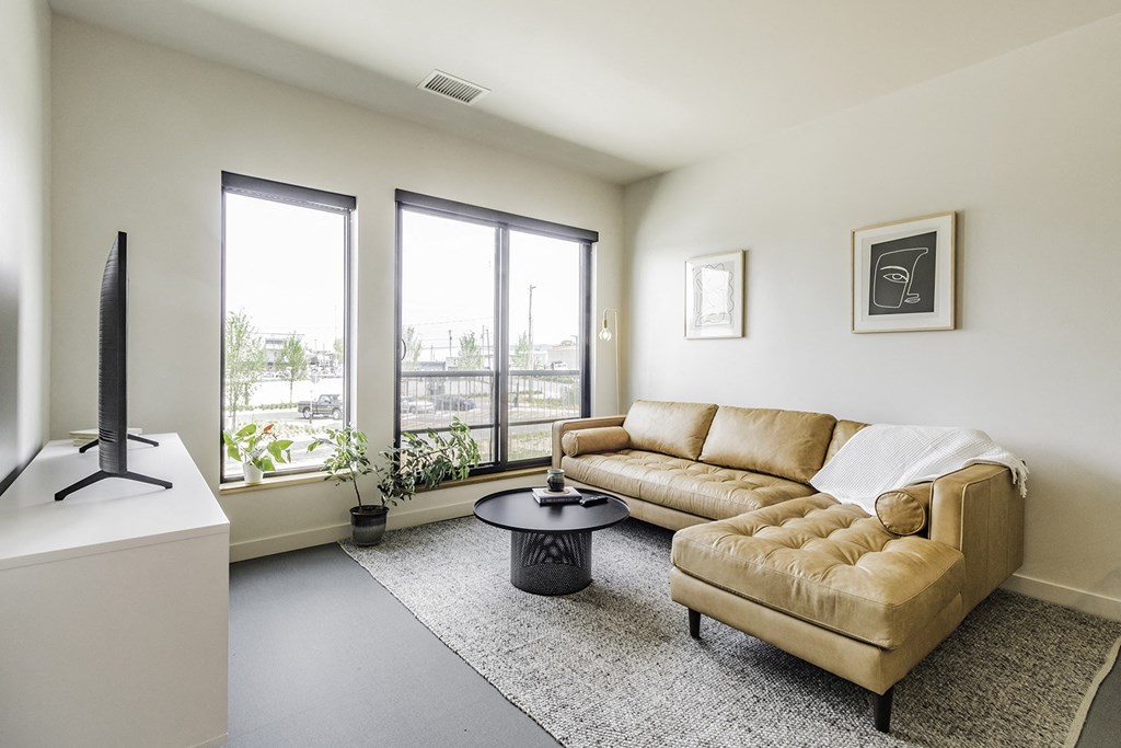 Studio, one and two bedroom apartment homes with stainless steel appliances, quartz countertops, backlit mirrors and large windows at 202 Railside in Springdale, AR