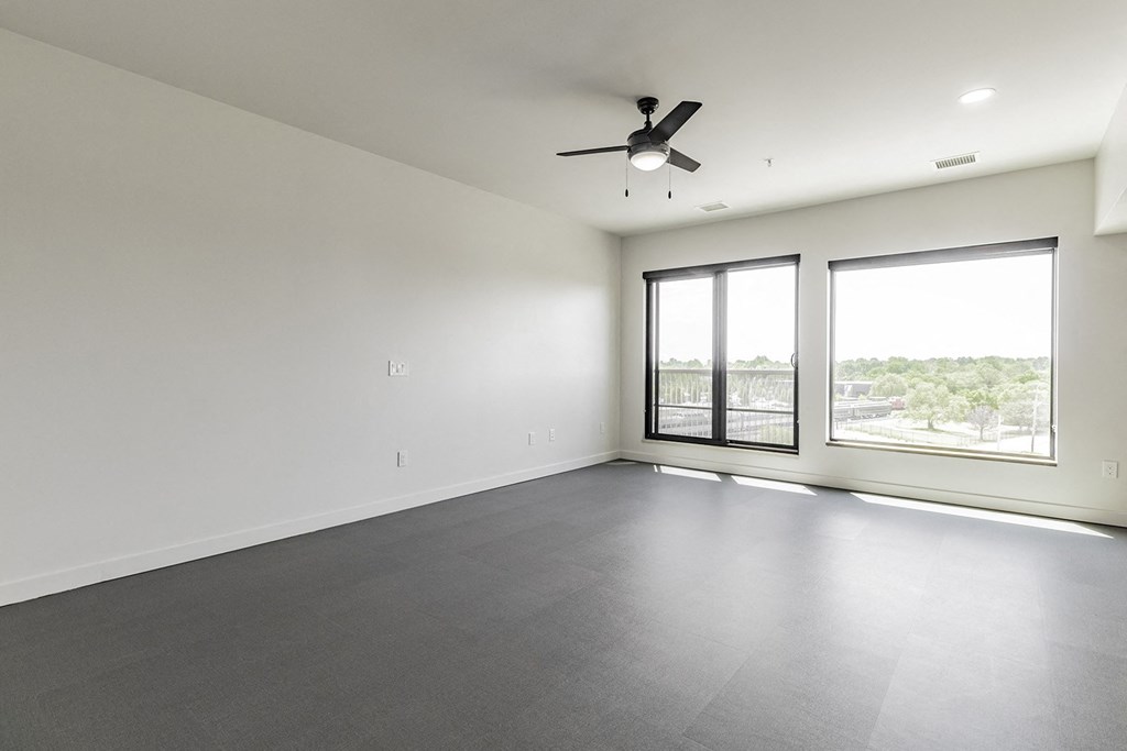 Studio, one and two bedroom apartment homes with stainless steel appliances, quartz countertops, backlit mirrors and large windows at 202 Railside in Springdale, AR