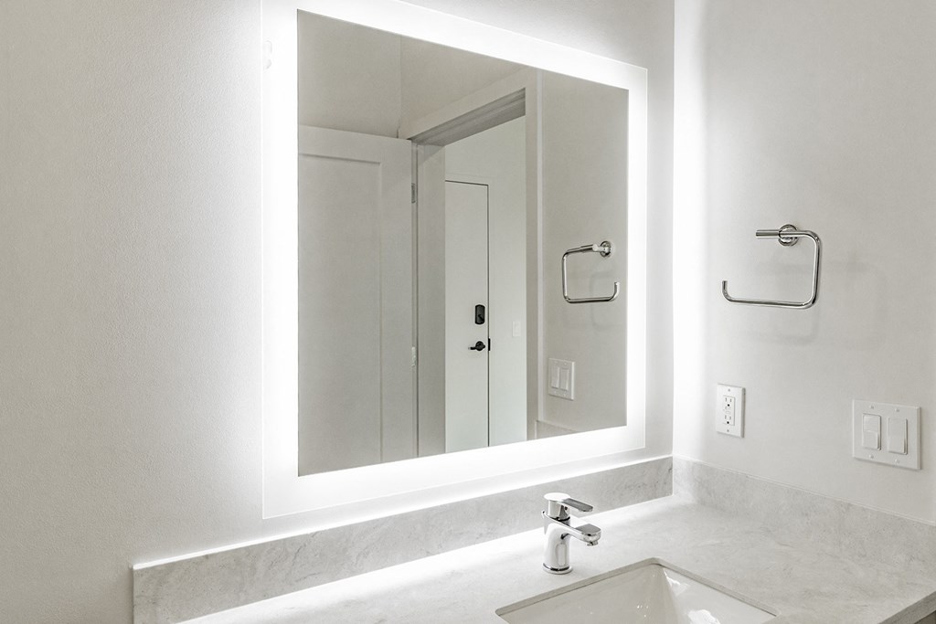 Studio, one and two bedroom apartment homes with stainless steel appliances, quartz countertops, backlit mirrors and large windows at 202 Railside in Springdale, AR