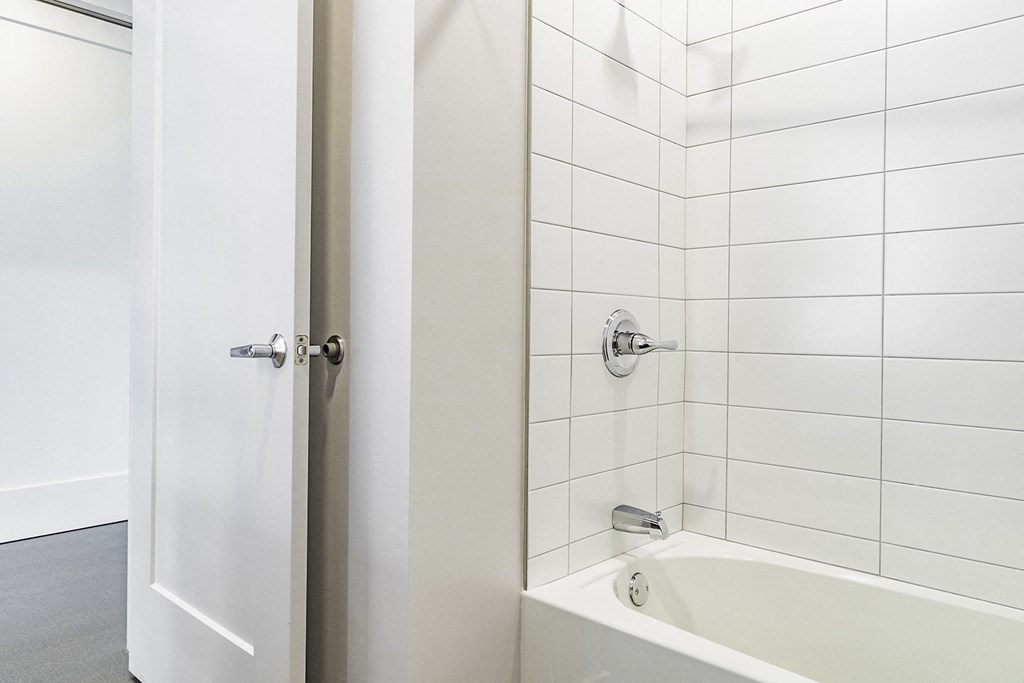 Studio, one and two bedroom apartment homes with stainless steel appliances, quartz countertops, backlit mirrors and large windows at 202 Railside in Springdale, AR