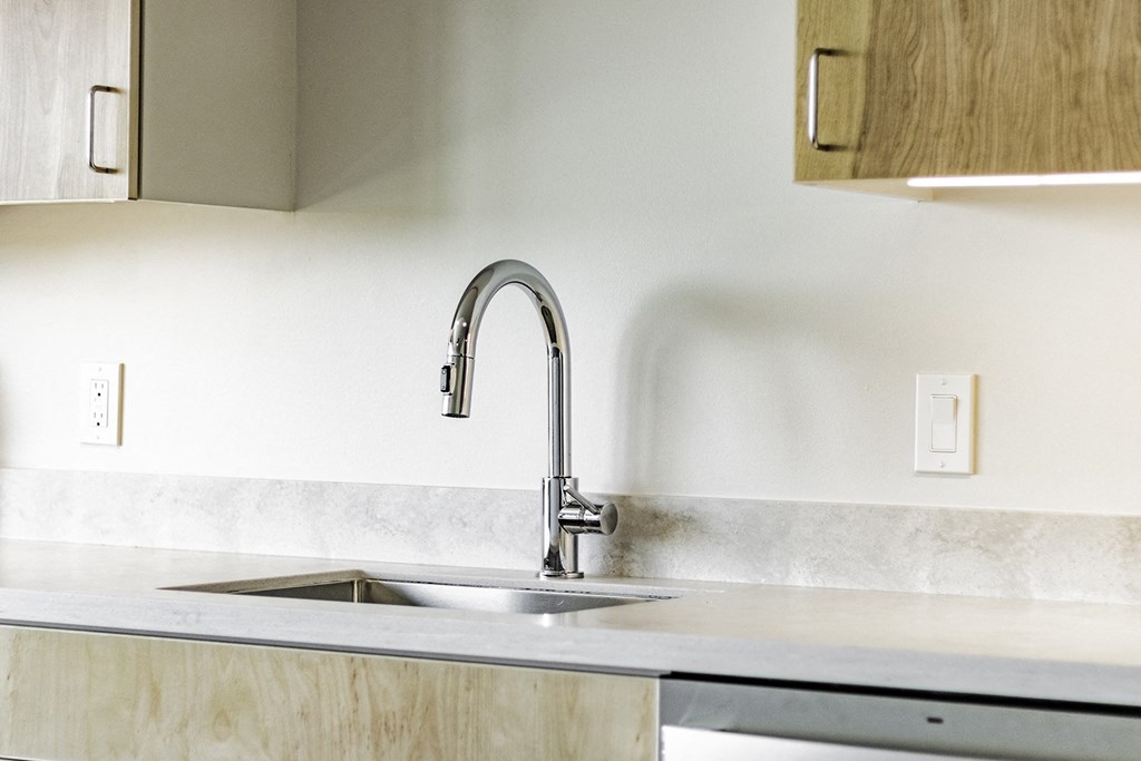 Studio, one and two bedroom apartment homes with stainless steel appliances, quartz countertops, backlit mirrors and large windows at 202 Railside in Springdale, AR