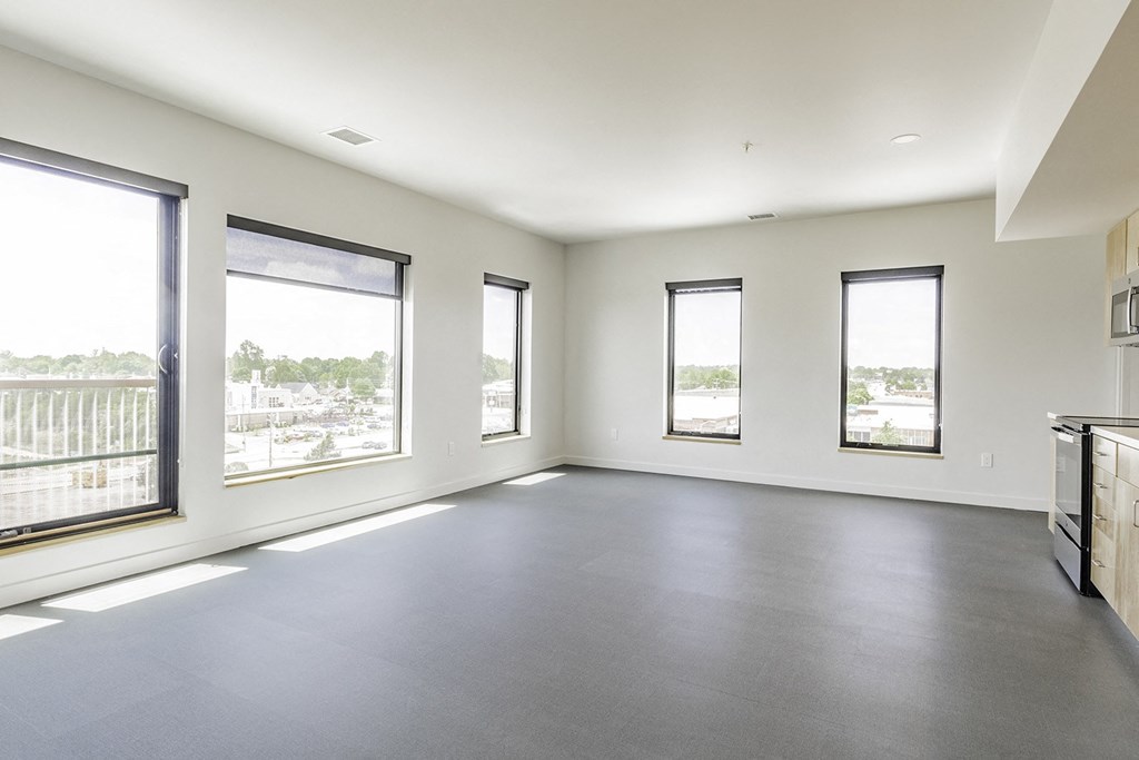 Studio, one and two bedroom apartment homes with stainless steel appliances, quartz countertops, backlit mirrors and large windows at 202 Railside in Springdale, AR