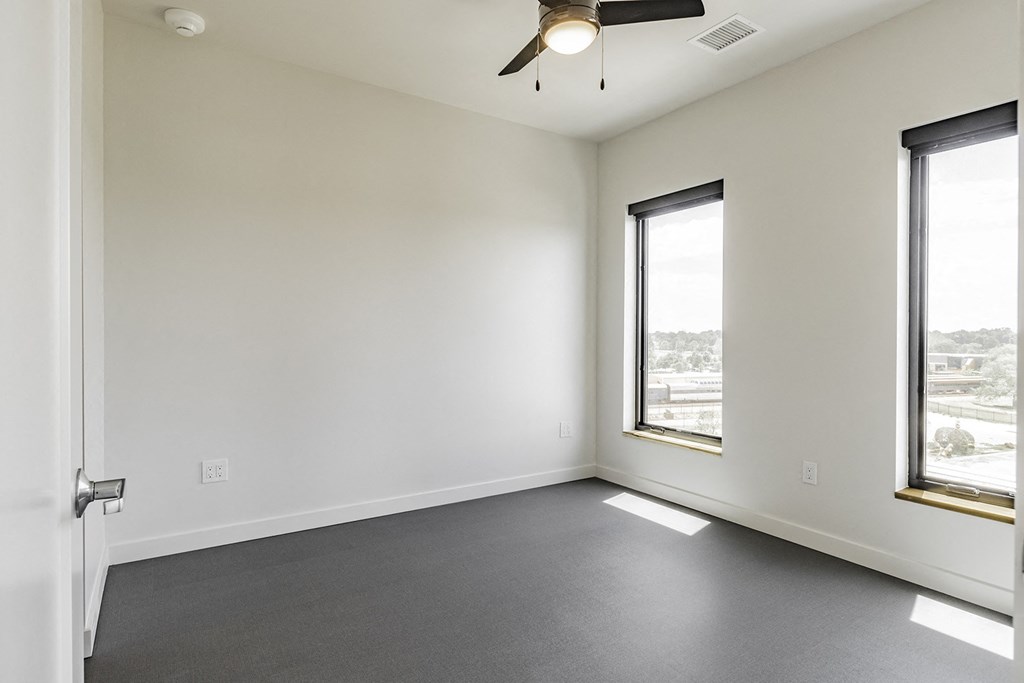 Studio, one and two bedroom apartment homes with stainless steel appliances, quartz countertops, backlit mirrors and large windows at 202 Railside in Springdale, AR