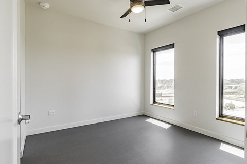 Studio, one and two bedroom apartment homes with stainless steel appliances, quartz countertops, backlit mirrors and large windows at 202 Railside in Springdale, AR
