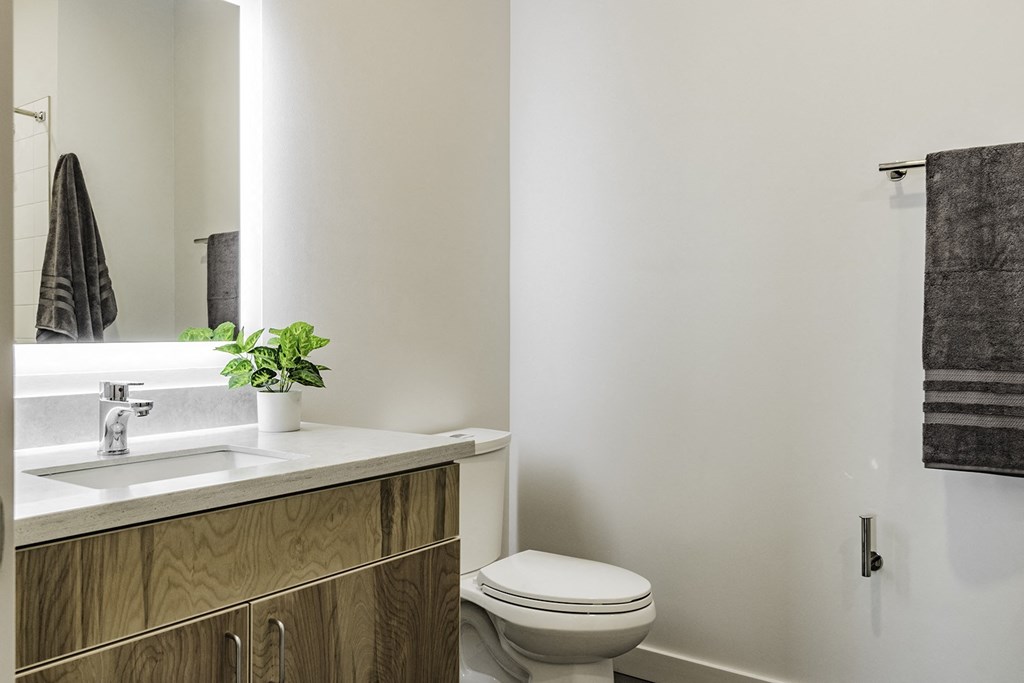 Studio, one and two bedroom apartment homes with stainless steel appliances, quartz countertops, backlit mirrors and large windows at 202 Railside in Springdale, AR