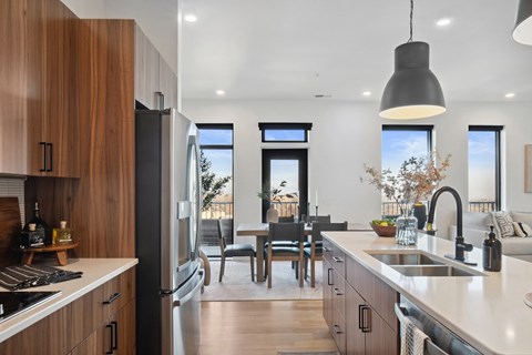 A modern kitchen with wooden cabinets and a large island.