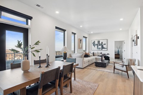 A modern living room with a dining table and chairs.