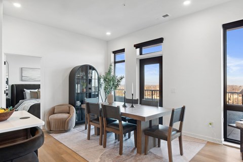 A dining room with a table set for four.
