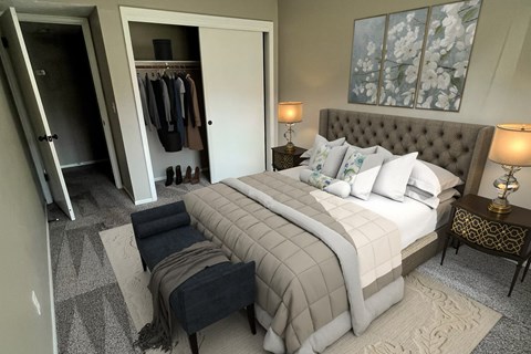 A bedroom with a large bed and a wardrobe.
