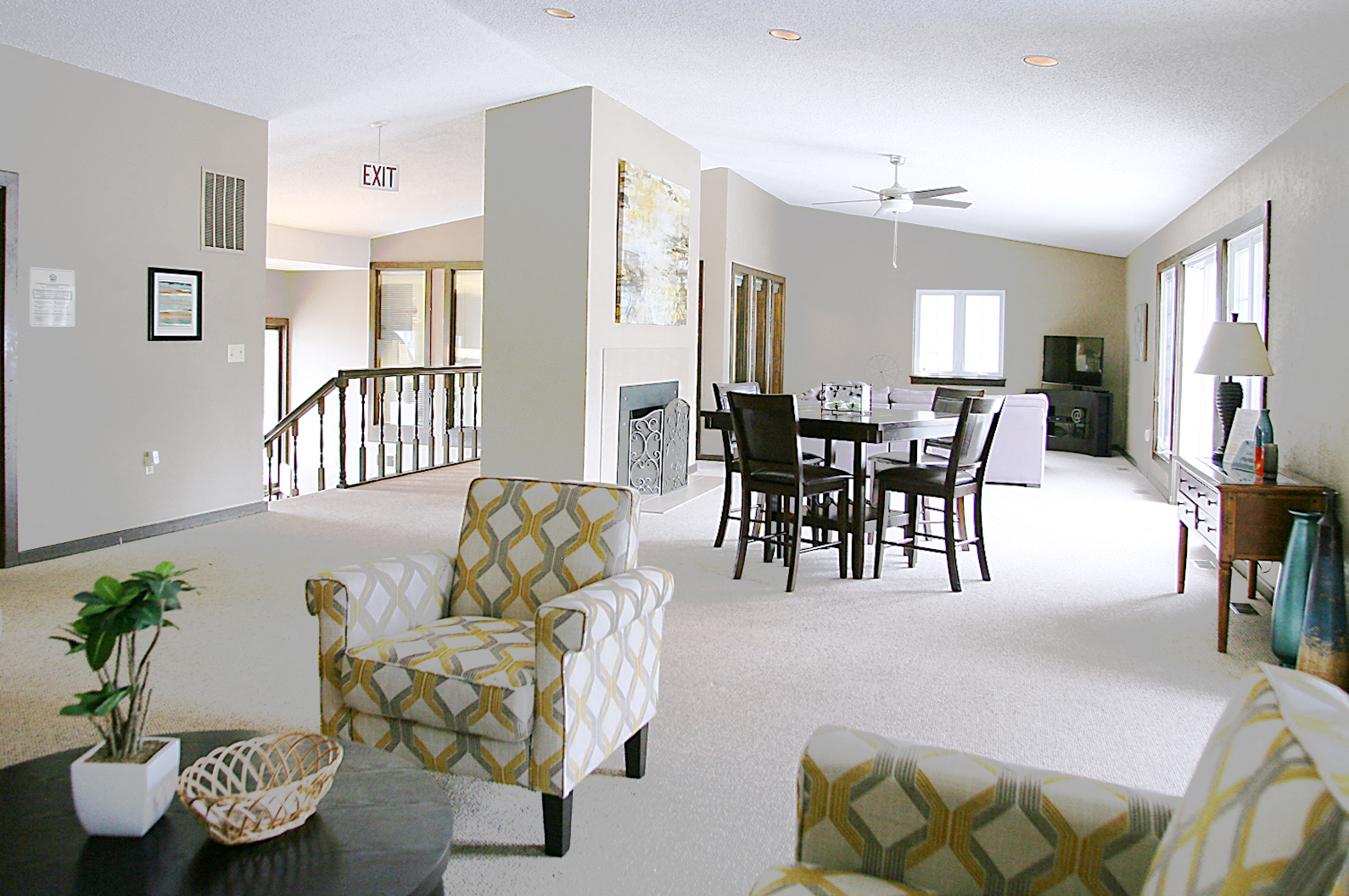 a living room and dining room with a table and chairs
