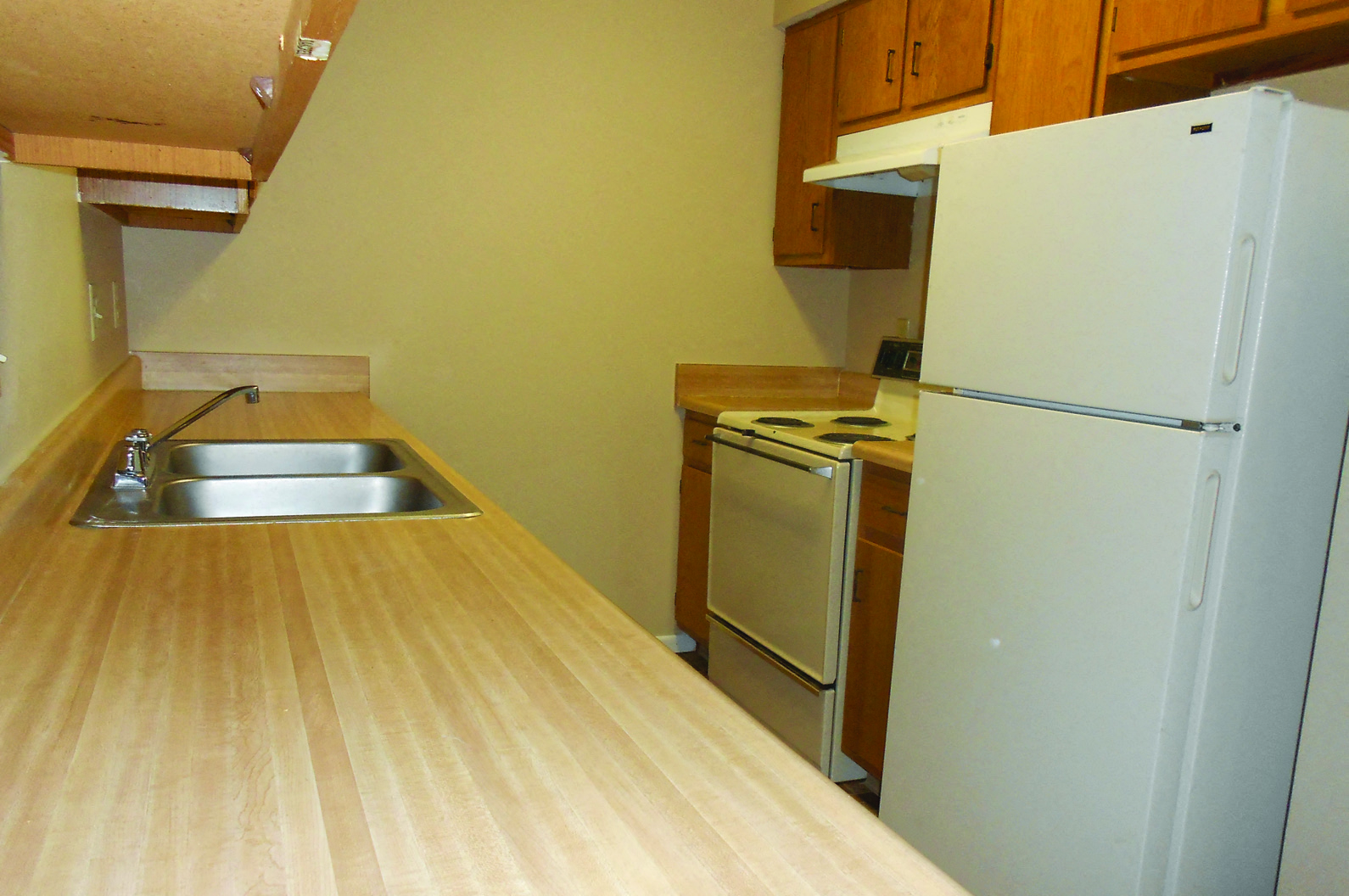 a kitchen with a sink and a refrigerator