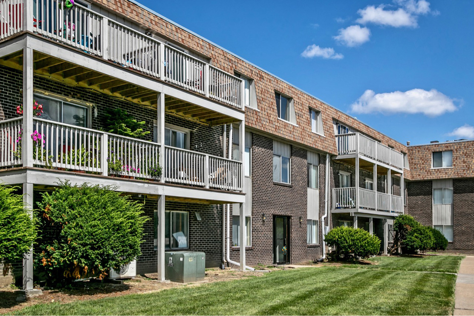 exterior view of a brick apartment building with balconies