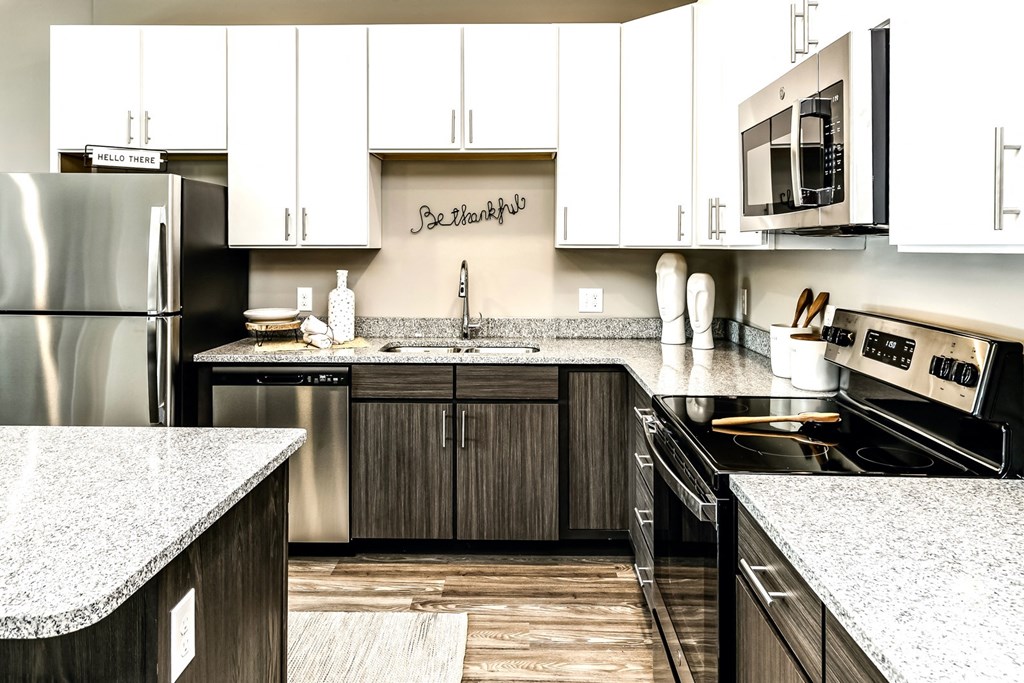 Two tone cabinet kitchens with extra storage and stainless steel appliances at AXIS apartments in Papillion, NE