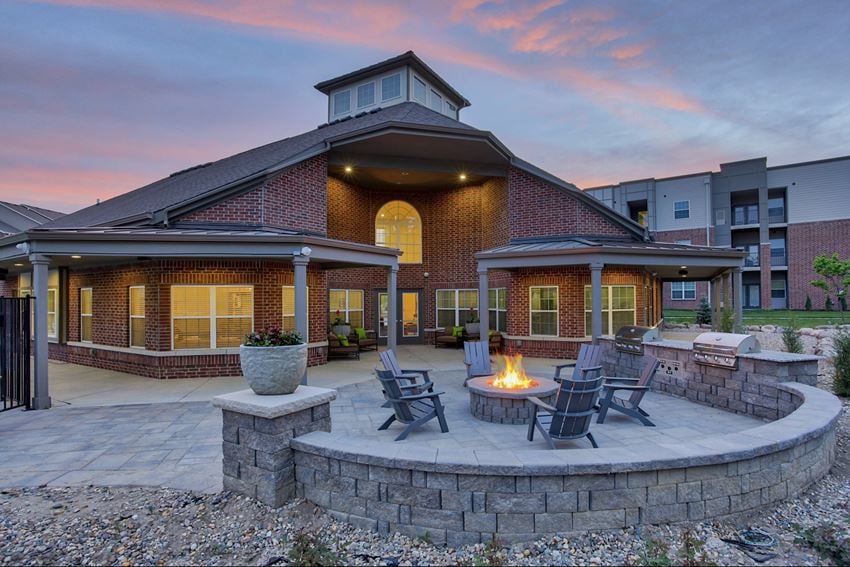 Clubhouse exterior with fire pits at The Apex at Twin Creek Apartments in Bellevue, NE - Photo Gallery 1