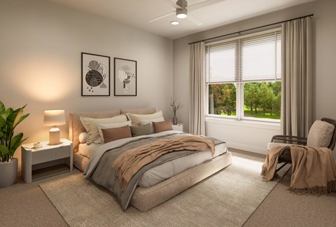 A well-lit bedroom with a large bed and a view of the outdoors through the window.