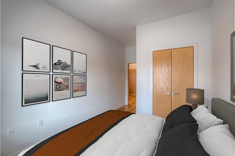 A bedroom with a bed and pictures on the wall.