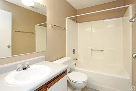 A white sink and toilet in a bathroom.