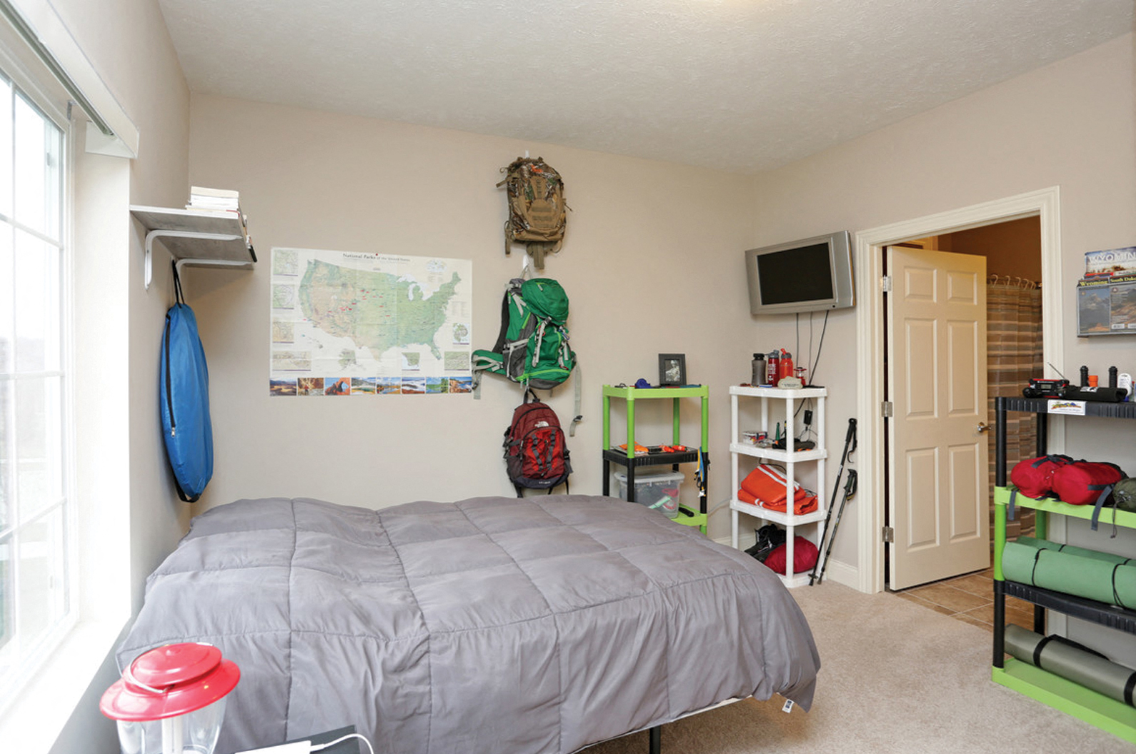 a bedroom with a bed and a door to a closet