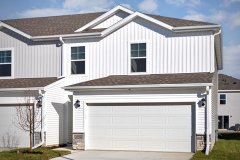 A white house with a garage door that says "Dover".