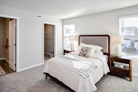 A bedroom with a large bed and a window.