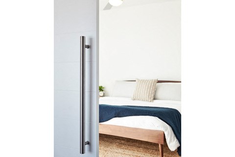 A bedroom with a bed and a door.