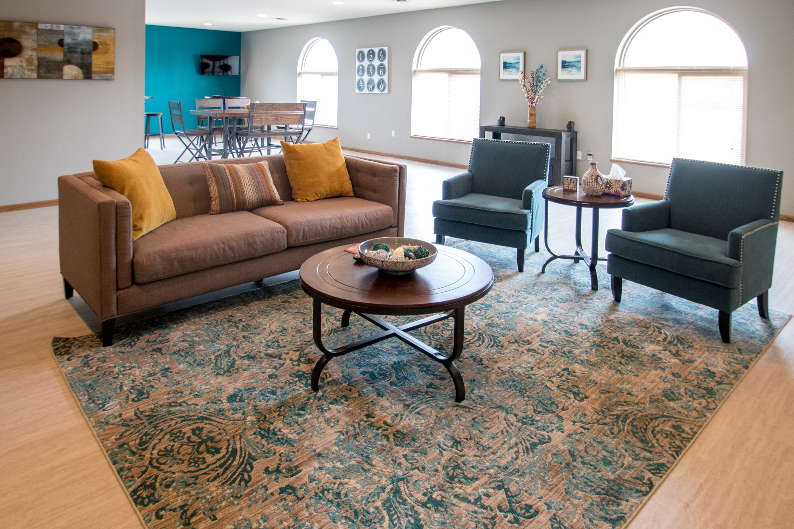 a living room with a couch and chairs and a rug