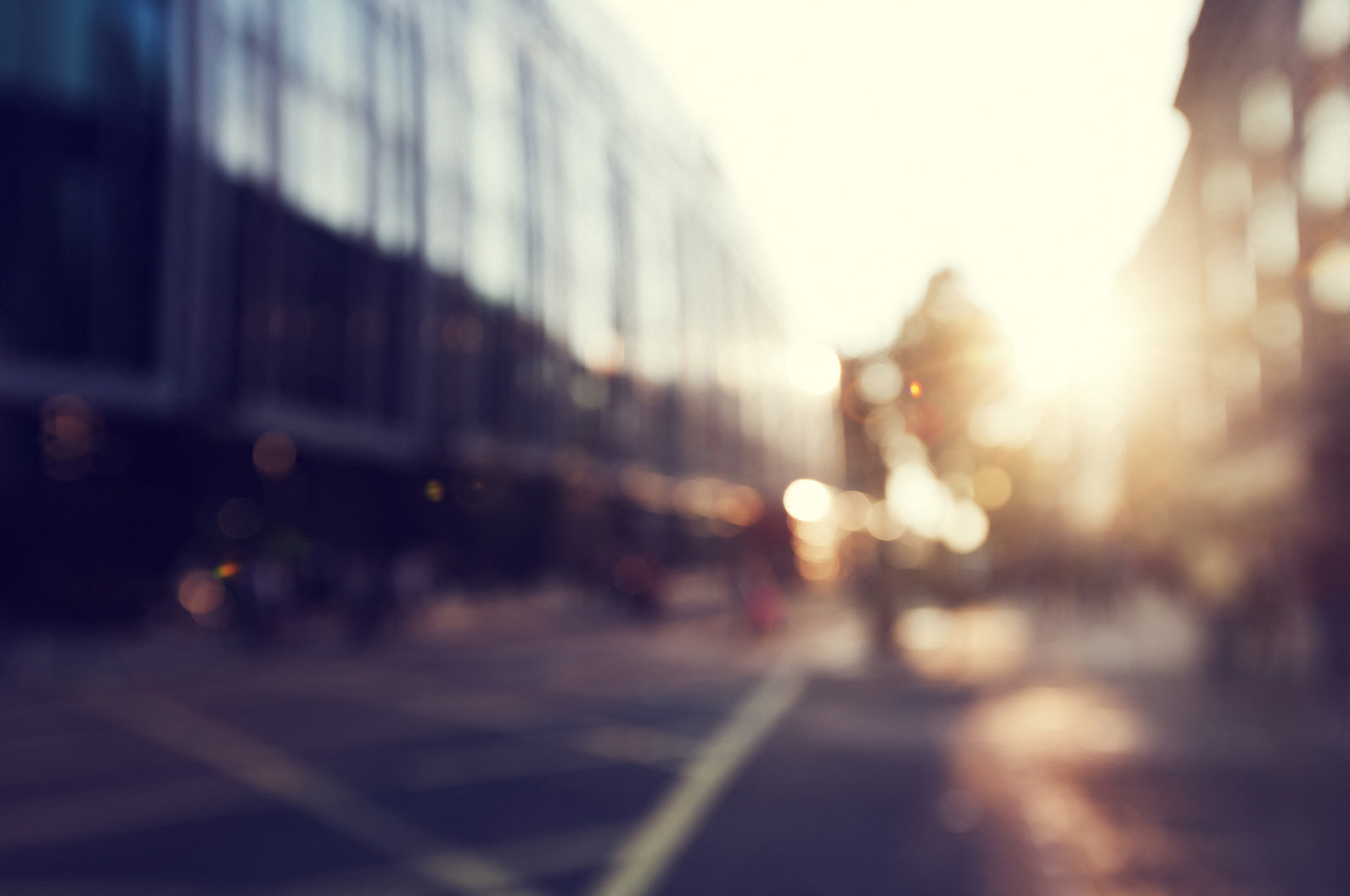 a city street with the sun shining on a building