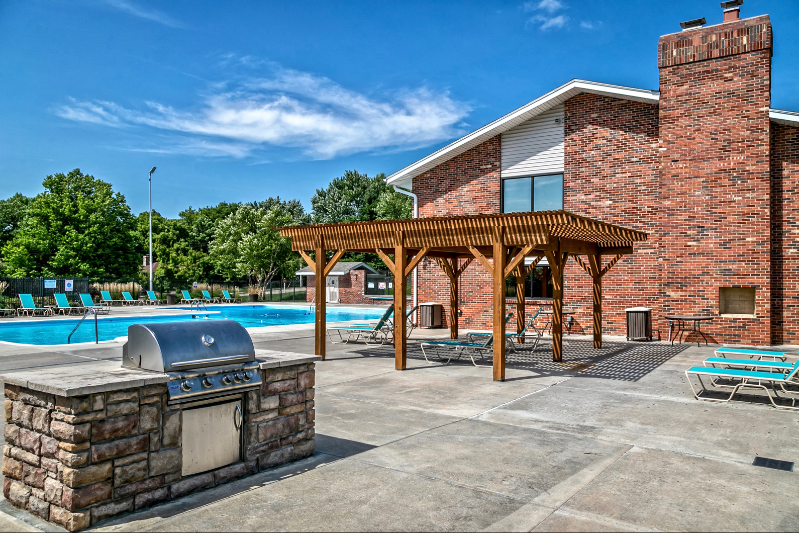 Olympic sized swimming pool with community grill at Club at Highland Park Apartments, Omaha, NE