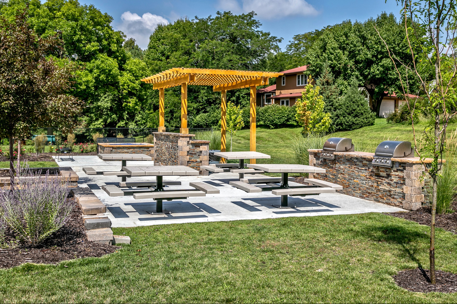 a seating area in a park with benches and a pavilion