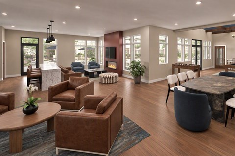 A living room with brown leather furniture and a fireplace.