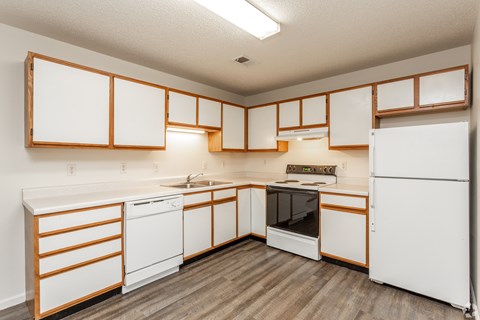 A kitchen with white appliances and wooden accents.