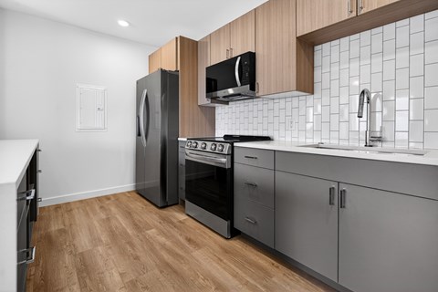 A modern kitchen with wooden cabinets and stainless steel appliances.