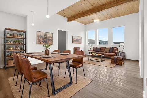 A dining room with a wooden table and chairs.