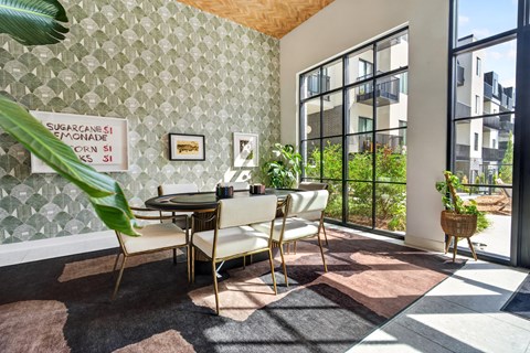 A dining area with a table and chairs.