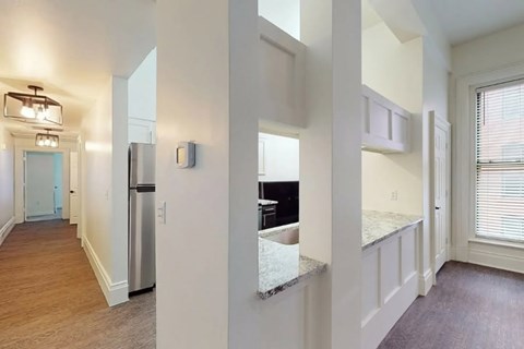 A kitchen with a stainless steel refrigerator and a countertop.