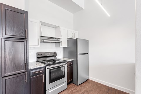 A kitchen with a stove, oven, and refrigerator.