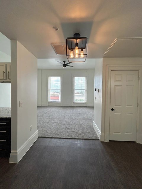 A room with a ceiling fan and a light fixture.