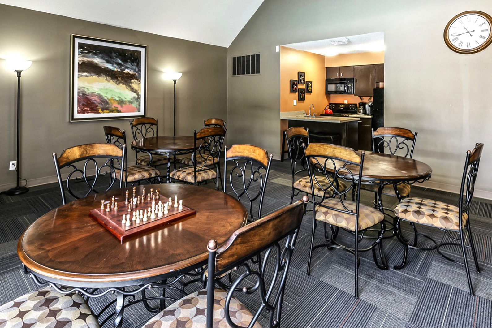 a game room with tables and chairs and a chess board