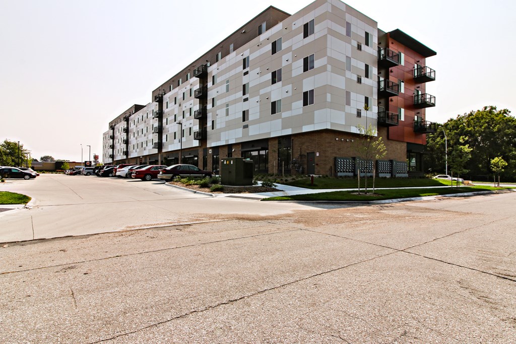 an apartment building on the corner of a city street
