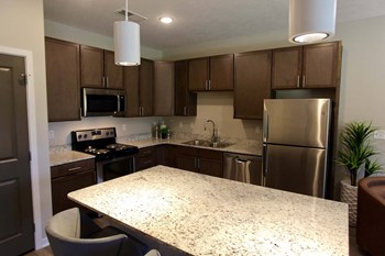 Large kitchens with stainless steel appliances and granite countertops at The Flats at 5th in Columbus, NE - Photo Gallery 4