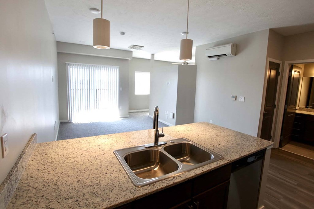 Large kitchens with stainless steel appliances and granite countertops at The Flats at 5th in Columbus, NE