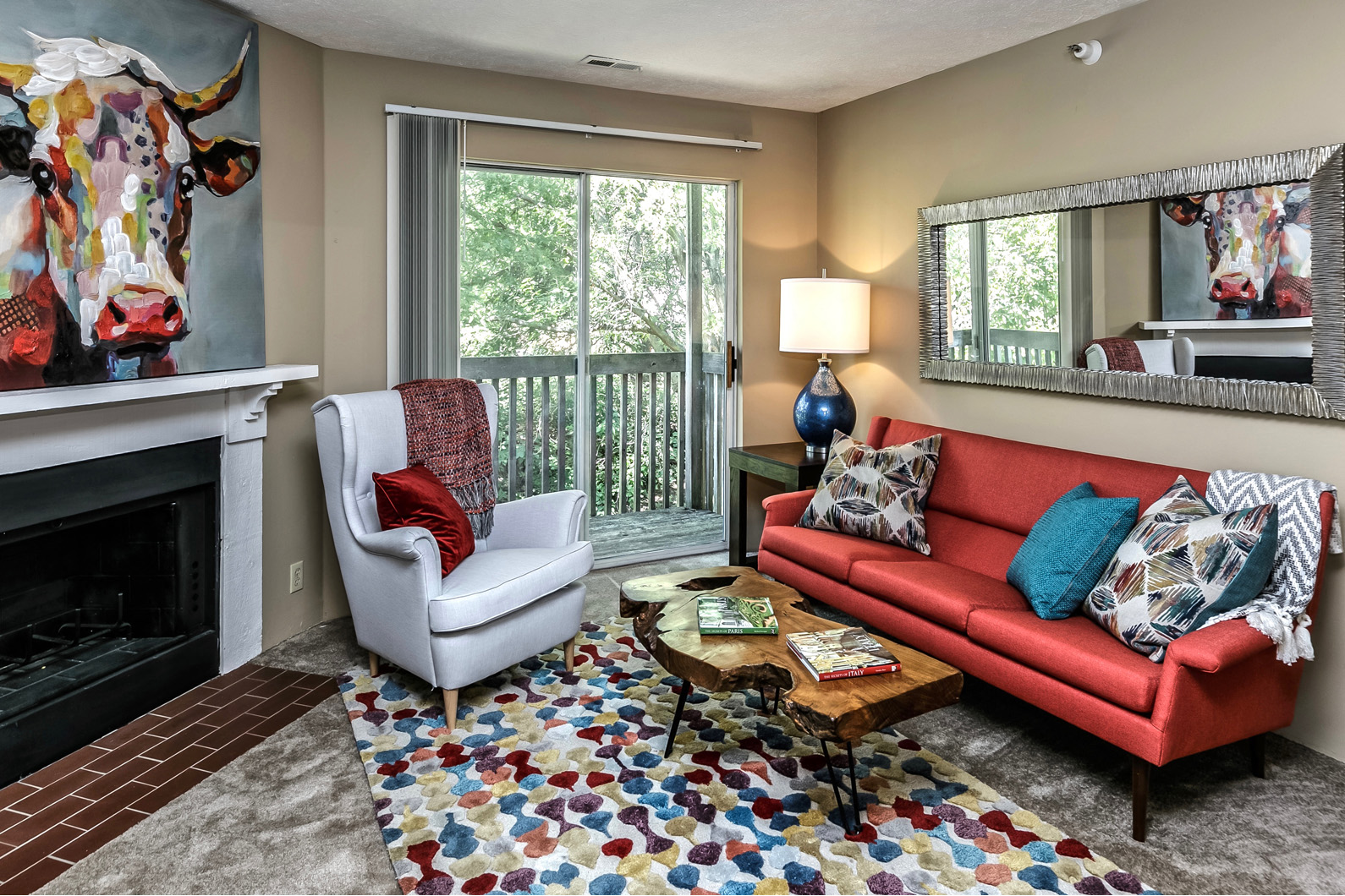 a living room with a red couch and a fireplace