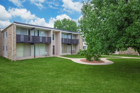 A building with a green lawn in front of it.