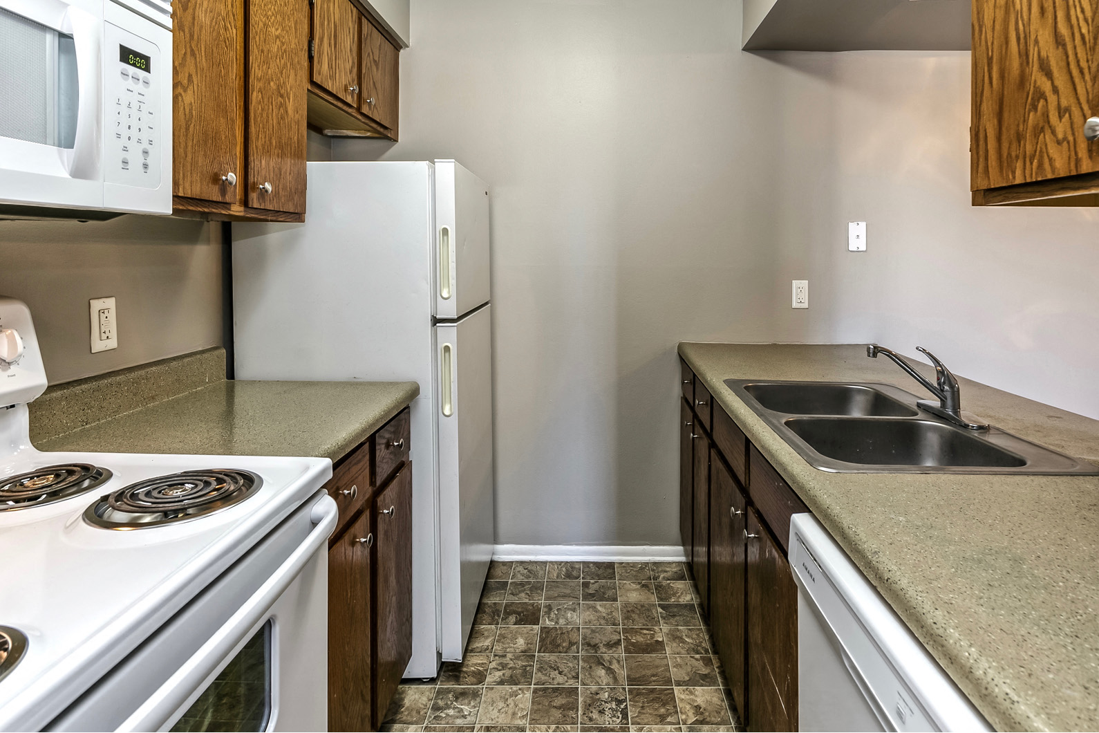 a kitchen with a stove sink and refrigerator
