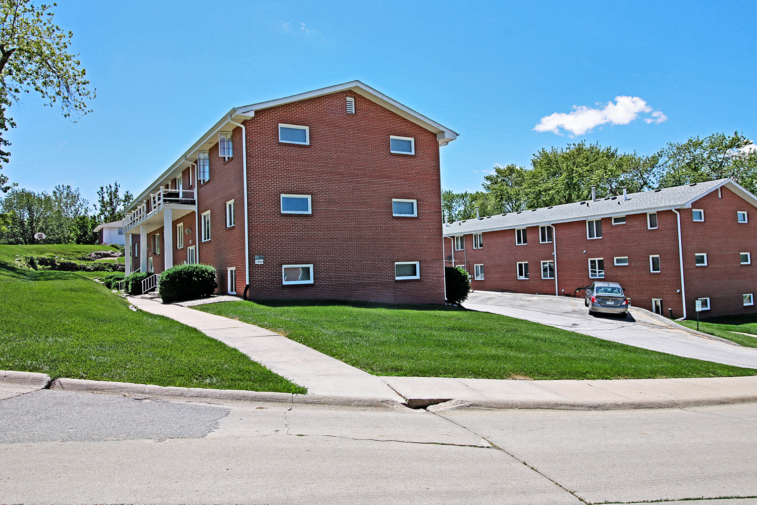 an apartment building with a car parked in front of it