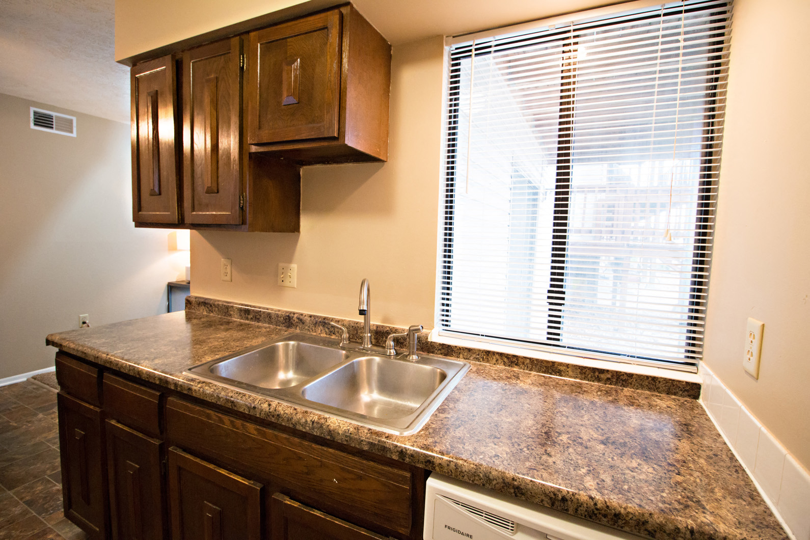 a kitchen with a sink and a window