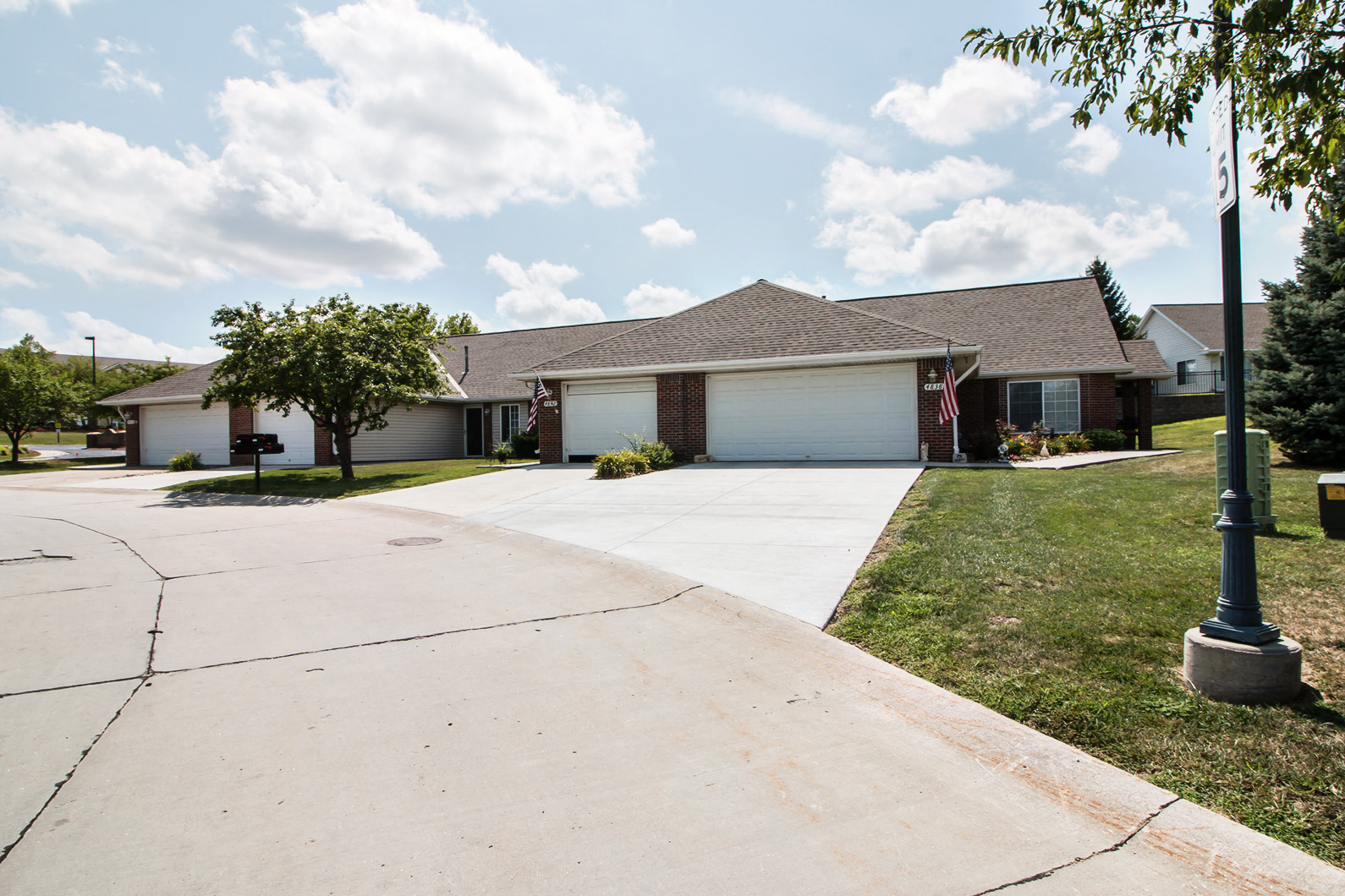 the front of a house with a driveway and a garage door