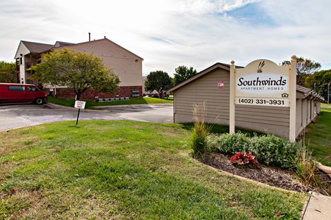 a sign for southwoods apartments in front of a parking lot